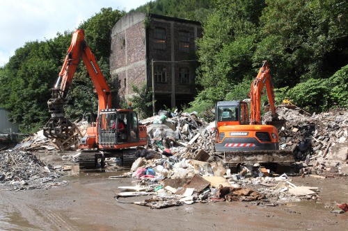 heavy machinery sorting waste for recycling
