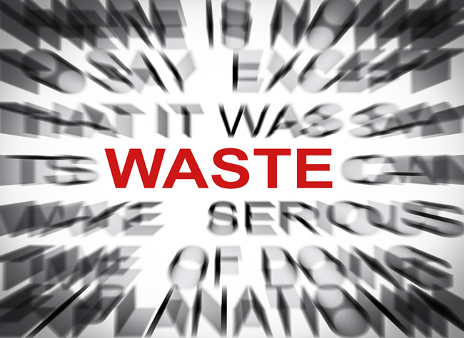 Image of the word Waste in red with text around blurred to only show off 'waste'