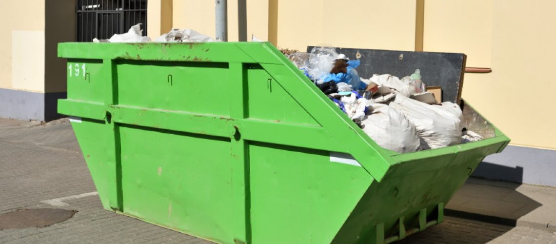 Green skip (dumpster) for municipal waste or industrial waste on street